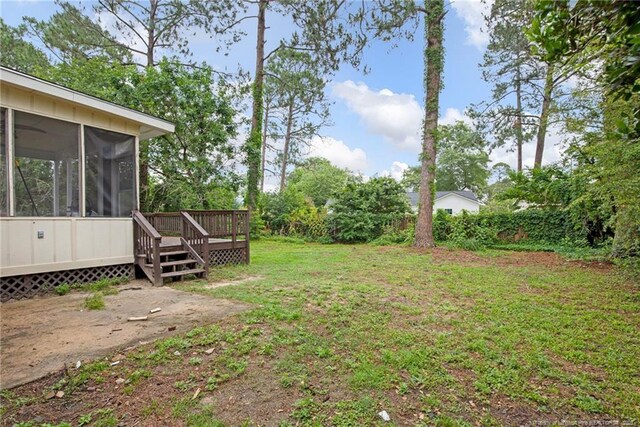 3855 Sturbridge Dr, Hope Mills, NC 28348 - view of grassy yard with a sunroom and a wooden deck