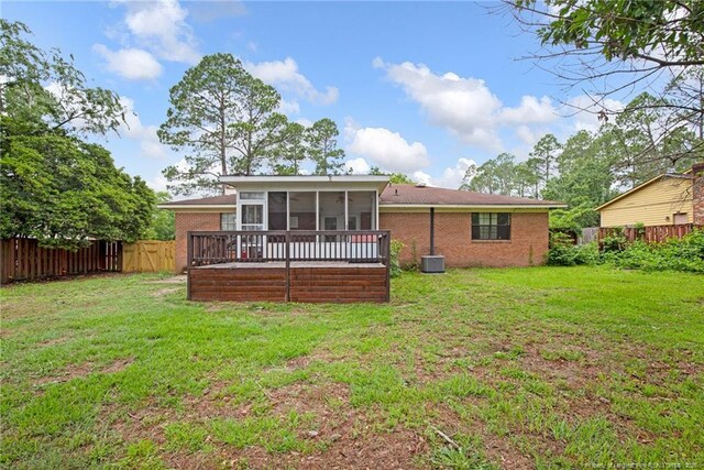 3855 Sturbridge Dr, Hope Mills, NC 28348 - rear view of property with a sunroom, brick siding, and central AC