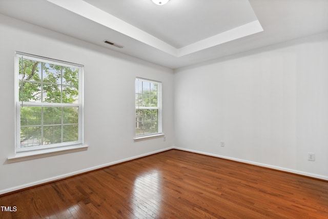 3141 Rapid Falls Rd, Cary, NC 27519 - empty room featuring hardwood / wood-style flooring, baseboards, and a tray ceiling