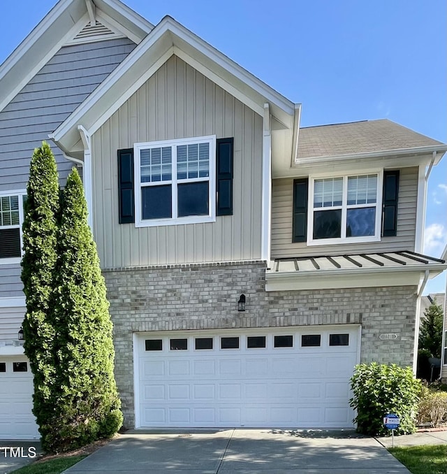 7241 Terregles Dr, Raleigh, NC 27617 - view of front of house with brick siding, a garage, concrete driveway, and board and batten siding