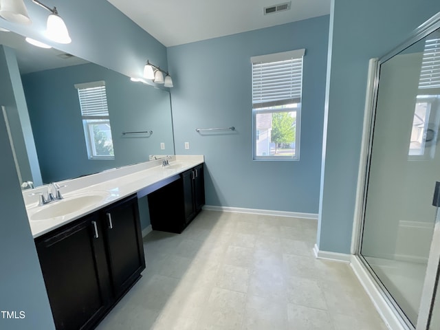 7241 Terregles Dr, Raleigh, NC 27617 - bathroom with double vanity, a shower stall, and baseboards