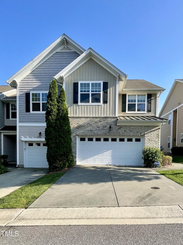 7241 Terregles Dr, Raleigh, NC 27617 - view of front facade featuring a garage, concrete driveway, and board and batten siding
