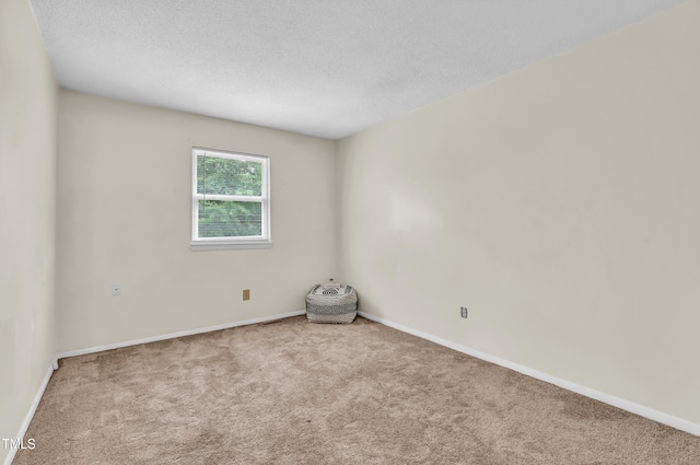 1220 Manassas Ct Unit B, Raleigh, NC 27609 - spare room featuring carpet flooring, baseboards, and a textured ceiling