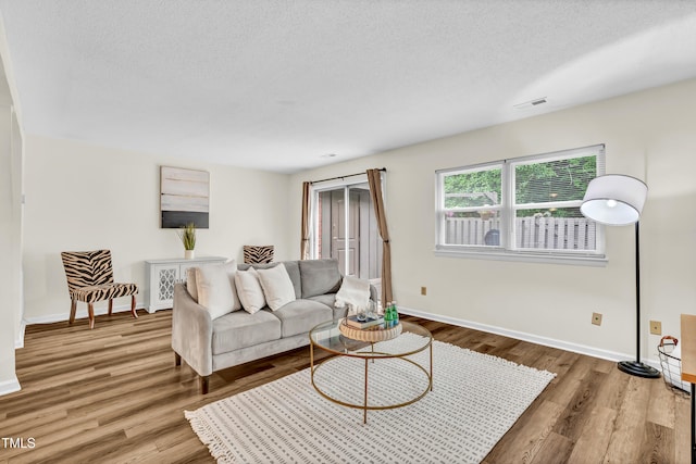 1220 Manassas Ct Unit B, Raleigh, NC 27609 - living room with baseboards, wood finished floors, and a textured ceiling