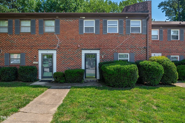 1220 Manassas Ct Unit B, Raleigh, NC 27609 - townhome / multi-family property featuring a front lawn and brick siding