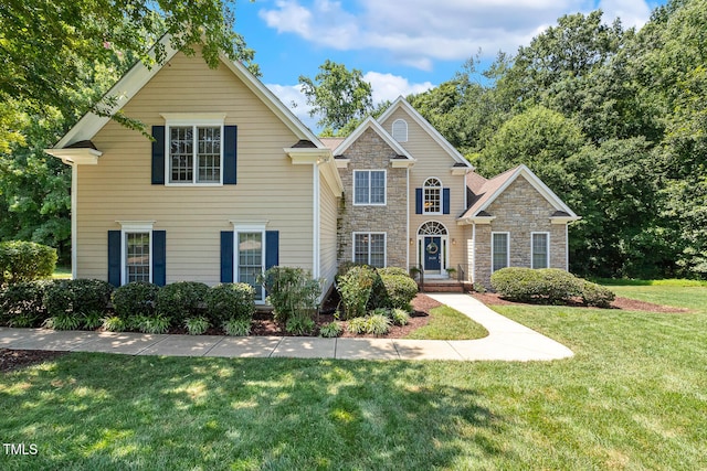2628 Hunters Meadow Ln, Raleigh, NC 27606 - traditional-style house with stone siding and a front yard