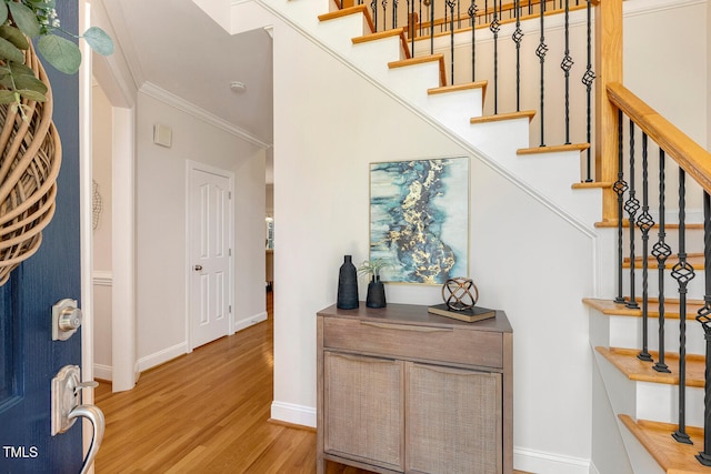 2628 Hunters Meadow Ln, Raleigh, NC 27606 - entryway with light wood-style flooring, crown molding, and stairs
