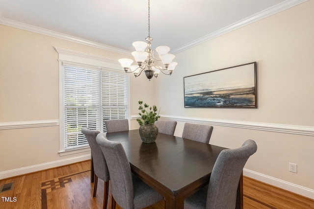 2628 Hunters Meadow Ln, Raleigh, NC 27606 - dining room with a chandelier, crown molding, and wood finished floors