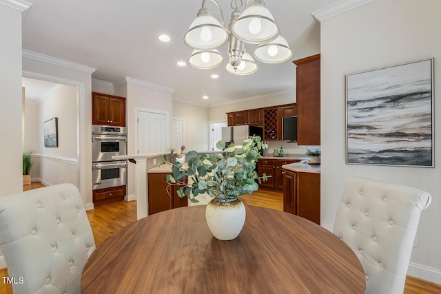 2628 Hunters Meadow Ln, Raleigh, NC 27606 - dining space featuring a chandelier, light wood-style floors, recessed lighting, and crown molding