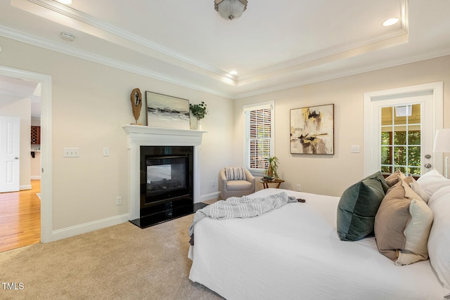 2628 Hunters Meadow Ln, Raleigh, NC 27606 - bedroom with ornamental molding, a raised ceiling, multiple windows, a glass covered fireplace, and access to exterior