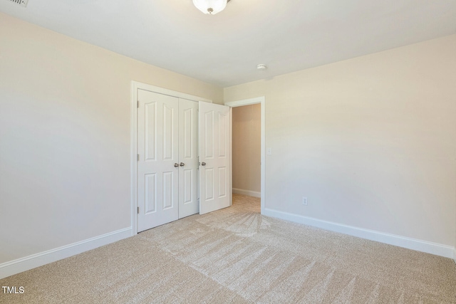 2628 Hunters Meadow Ln, Raleigh, NC 27606 - unfurnished bedroom with light carpet and a closet