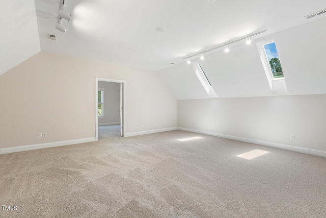 2628 Hunters Meadow Ln, Raleigh, NC 27606 - additional living space with vaulted ceiling, light colored carpet, and a skylight
