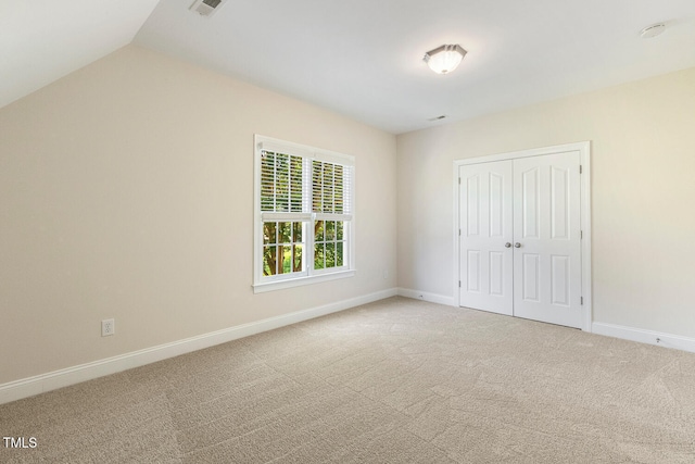 2628 Hunters Meadow Ln, Raleigh, NC 27606 - unfurnished bedroom featuring carpet, a closet, and vaulted ceiling