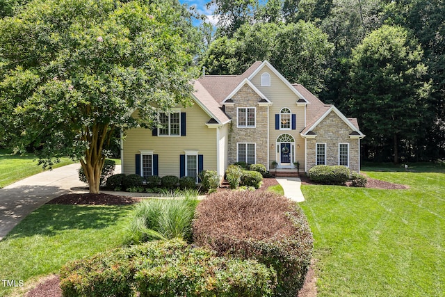 2628 Hunters Meadow Ln, Raleigh, NC 27606 - traditional-style house featuring stone siding and a front lawn