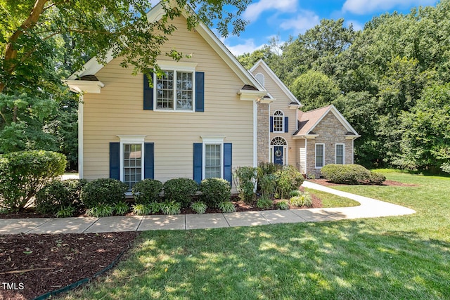 2628 Hunters Meadow Ln, Raleigh, NC 27606 - traditional-style home featuring a front lawn and stone siding