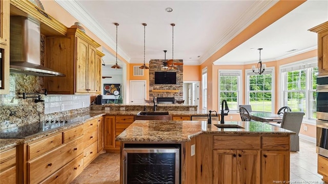 330 Wellington Rd, Saint Pauls, NC 28384 - kitchen featuring beverage cooler, wall chimney range hood, black electric stovetop, a stone fireplace, and tasteful backsplash