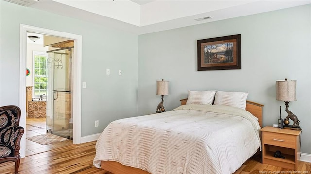 330 Wellington Rd, Saint Pauls, NC 28384 - bedroom with wood finished floors and ensuite bathroom