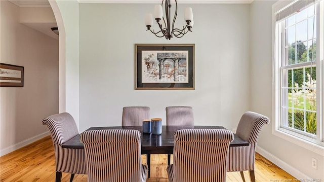 330 Wellington Rd, Saint Pauls, NC 28384 - dining room with light wood-style flooring, arched walkways, and a chandelier