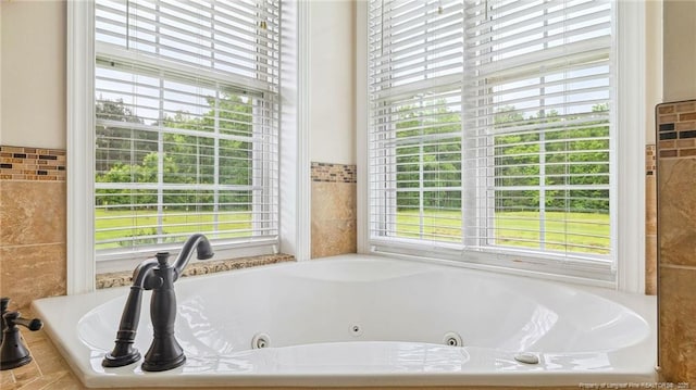 330 Wellington Rd, Saint Pauls, NC 28384 - bathroom featuring a jetted tub and tile walls