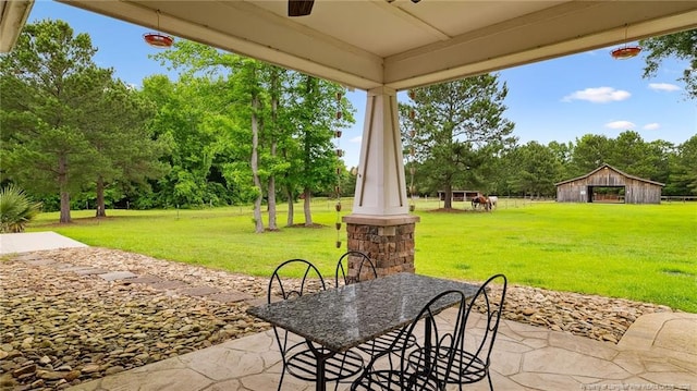 330 Wellington Rd, Saint Pauls, NC 28384 - view of patio with view of scattered trees and an outbuilding