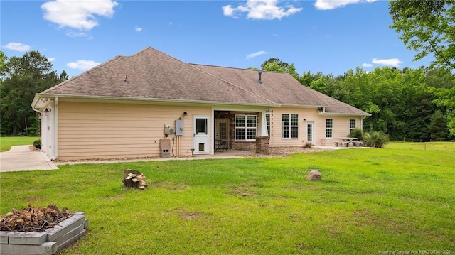 330 Wellington Rd, Saint Pauls, NC 28384 - rear view of house featuring a patio, a yard, and a shingled roof