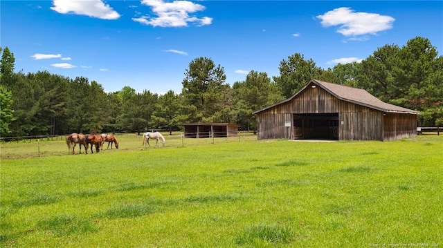 330 Wellington Rd, Saint Pauls, NC 28384 - view of yard with a garage, an outdoor structure, a pole building, and a wooded view