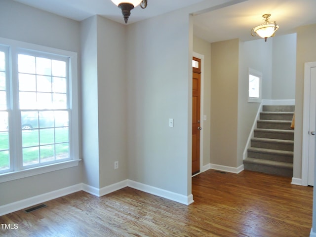 1104 Barrow Nook Ct, Apex, NC 27502 - spare room with wood finished floors, stairs, and baseboards