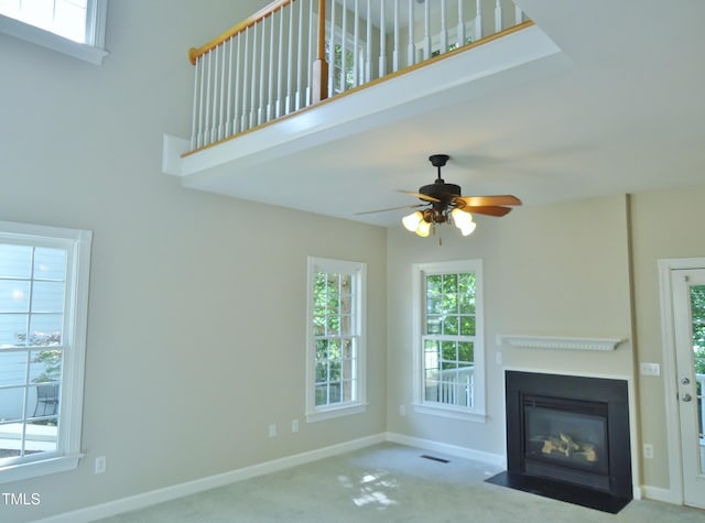 1104 Barrow Nook Ct, Apex, NC 27502 - unfurnished living room featuring a fireplace with flush hearth, carpet floors, baseboards, and ceiling fan