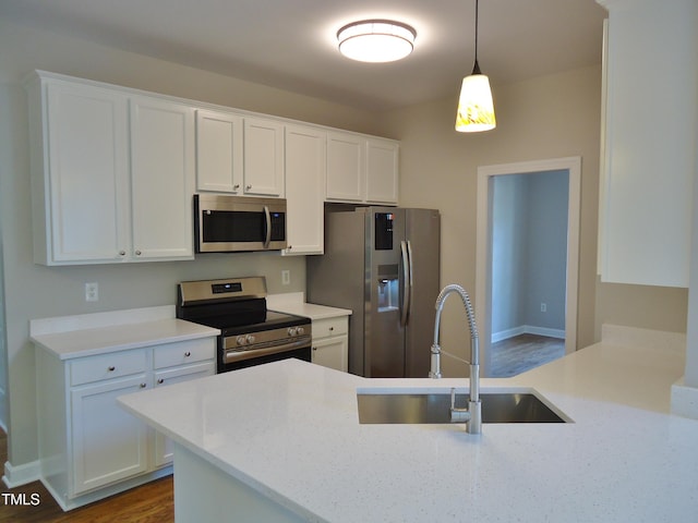 1104 Barrow Nook Ct, Apex, NC 27502 - kitchen with stainless steel appliances, a sink, white cabinetry, and hanging light fixtures