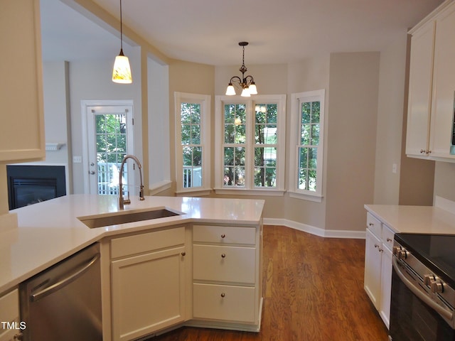 1104 Barrow Nook Ct, Apex, NC 27502 - kitchen featuring a sink, stainless steel appliances, dark wood-type flooring, and light countertops