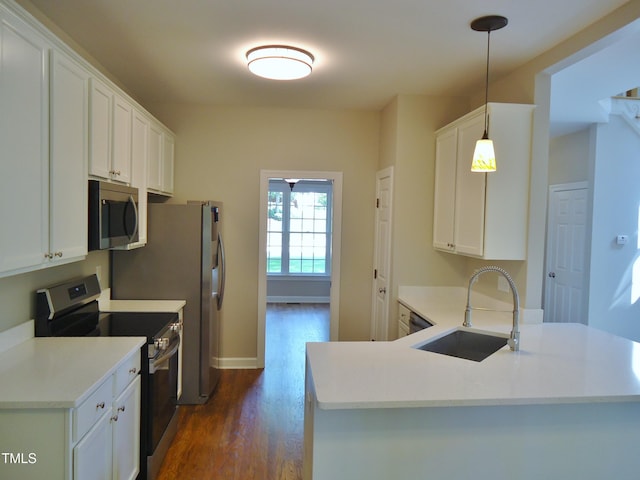 1104 Barrow Nook Ct, Apex, NC 27502 - kitchen with stainless steel appliances, a sink, dark wood-style flooring, white cabinets, and light countertops