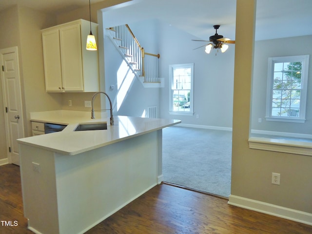 1104 Barrow Nook Ct, Apex, NC 27502 - kitchen with a sink, white cabinets, baseboards, ceiling fan, and light countertops