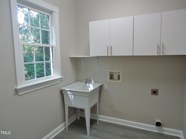 1104 Barrow Nook Ct, Apex, NC 27502 - laundry area featuring hookup for a washing machine, electric dryer hookup, cabinet space, and healthy amount of natural light