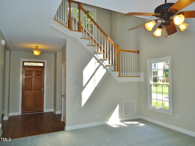 1104 Barrow Nook Ct, Apex, NC 27502 - entryway with stairway, carpet floors, baseboards, and a towering ceiling
