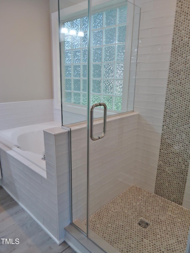 1104 Barrow Nook Ct, Apex, NC 27502 - bathroom with a stall shower, a garden tub, and wood finished floors