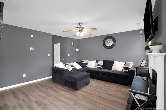 195 Cape Fear Rd, Raeford, NC 28376 - living area with a ceiling fan, light wood finished floors, baseboards, and a fireplace