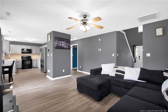 195 Cape Fear Rd, Raeford, NC 28376 - living room with ceiling fan, light wood-style flooring, and baseboards