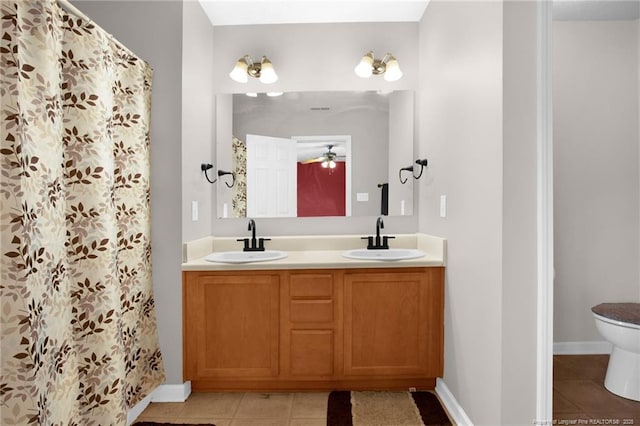 195 Cape Fear Rd, Raeford, NC 28376 - full bathroom featuring tile patterned flooring, toilet, double vanity, baseboards, and a ceiling fan