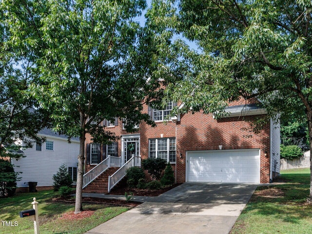313 Hardwick Dr, Durham, NC 27713 - view of front of home featuring a garage, concrete driveway, and brick siding
