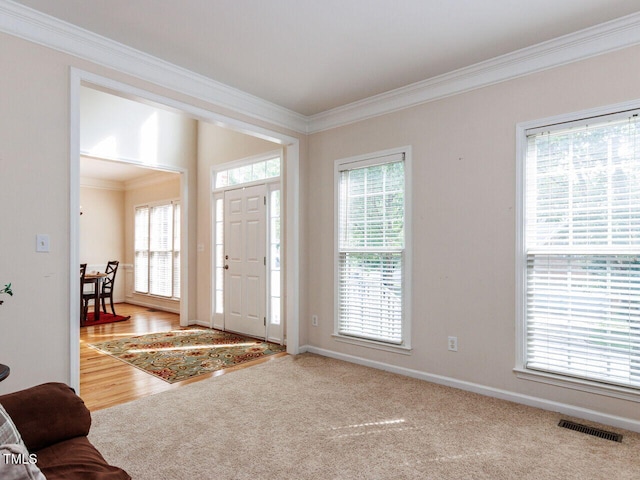 313 Hardwick Dr, Durham, NC 27713 - entryway featuring crown molding, plenty of natural light, and wood finished floors