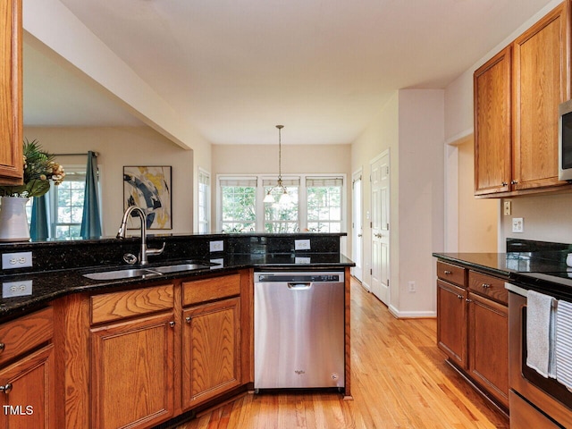 313 Hardwick Dr, Durham, NC 27713 - kitchen with appliances with stainless steel finishes, light wood finished floors, and plenty of natural light