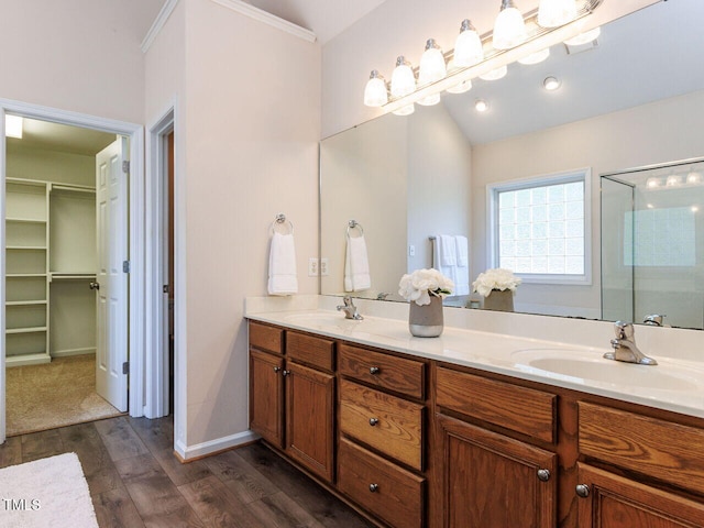 313 Hardwick Dr, Durham, NC 27713 - bathroom with double vanity, a stall shower, wood finished floors, and a spacious closet