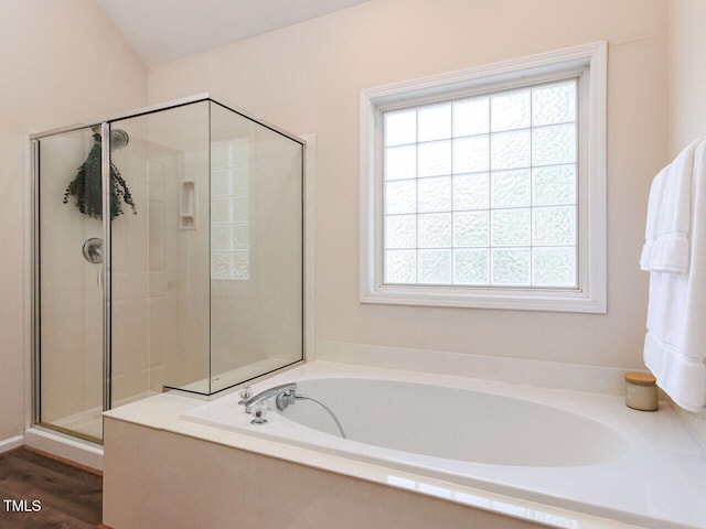 313 Hardwick Dr, Durham, NC 27713 - bathroom with a garden tub, a stall shower, and wood finished floors