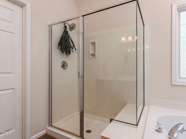 313 Hardwick Dr, Durham, NC 27713 - full bath featuring a shower stall, healthy amount of natural light, and a garden tub