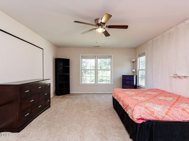 313 Hardwick Dr, Durham, NC 27713 - bedroom featuring multiple windows, light carpet, and a ceiling fan