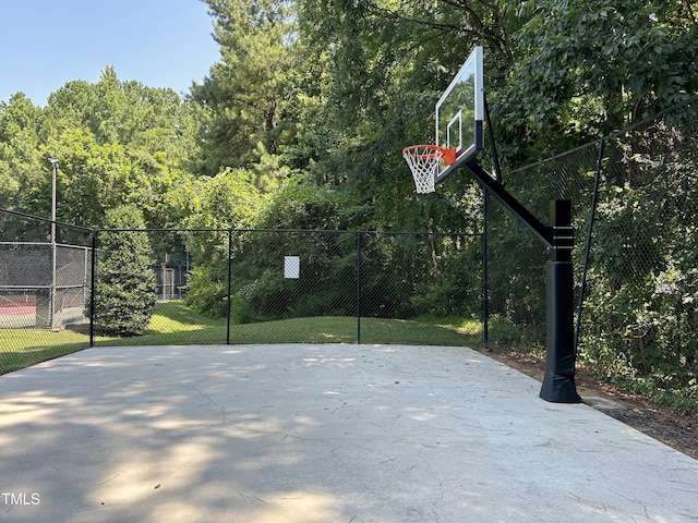 313 Hardwick Dr, Durham, NC 27713 - view of sport court with basketball hoop and a wooded view