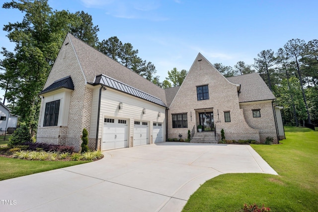 2713 Trifle Ln, Wake Forest, NC 27587 - view of front facade with brick siding, driveway, a front lawn, a standing seam roof, and a shingled roof