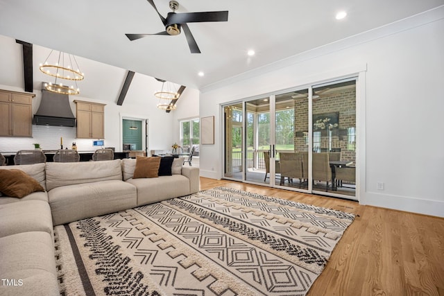 2713 Trifle Ln, Wake Forest, NC 27587 - living room featuring a chandelier, light wood-style flooring, baseboards, ceiling fan, and vaulted ceiling