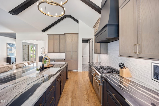 2713 Trifle Ln, Wake Forest, NC 27587 - kitchen with custom exhaust hood, a sink, light stone countertops, a chandelier, and high vaulted ceiling