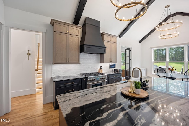 2713 Trifle Ln, Wake Forest, NC 27587 - kitchen with custom exhaust hood, high end stove, a chandelier, decorative backsplash, and light stone counters